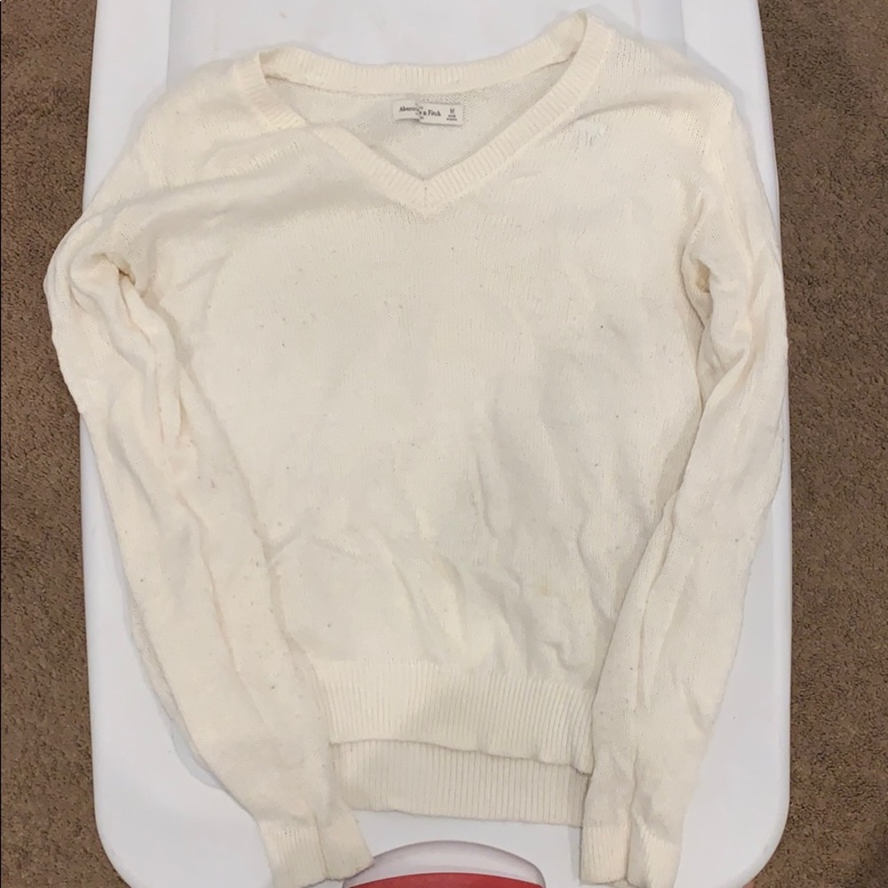 White/off white v-neck sweater.